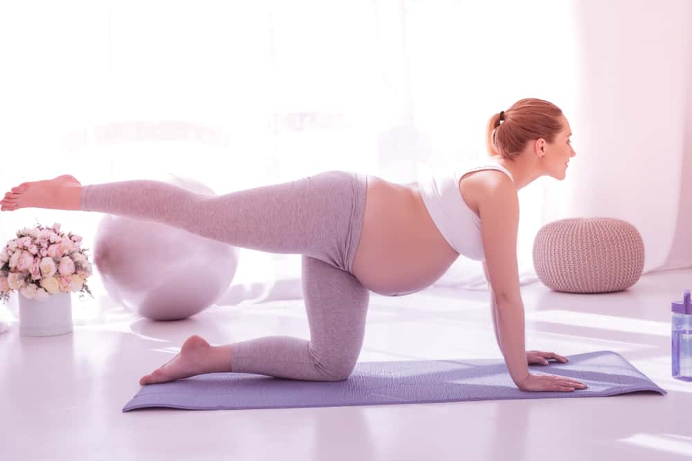 a pregnant woman practicing yoga