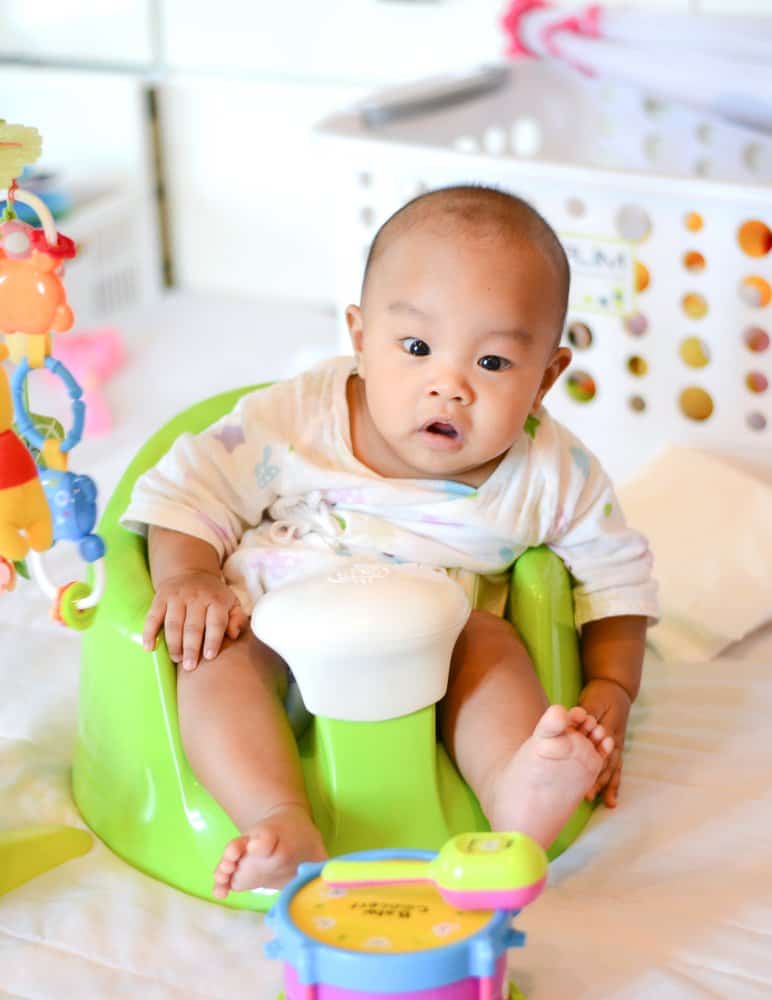 baby sitting on a baby floor seat