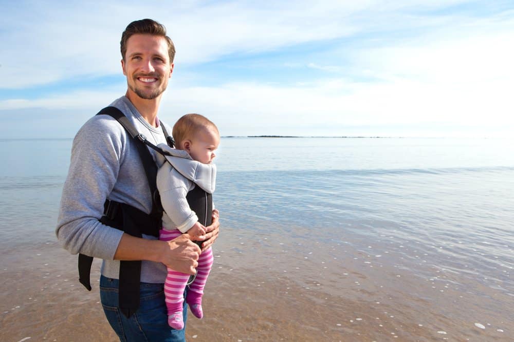 father using baby carrier