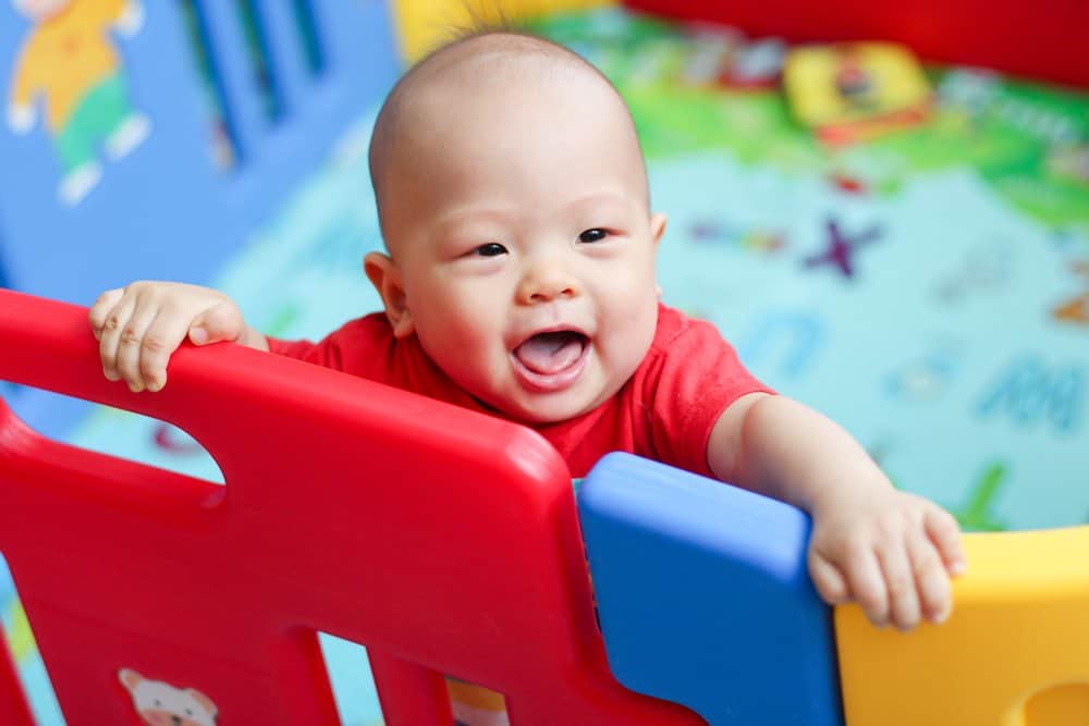 Baby in a red playpen