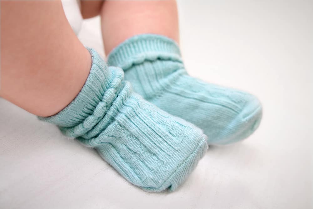 Baby wearing blue socks