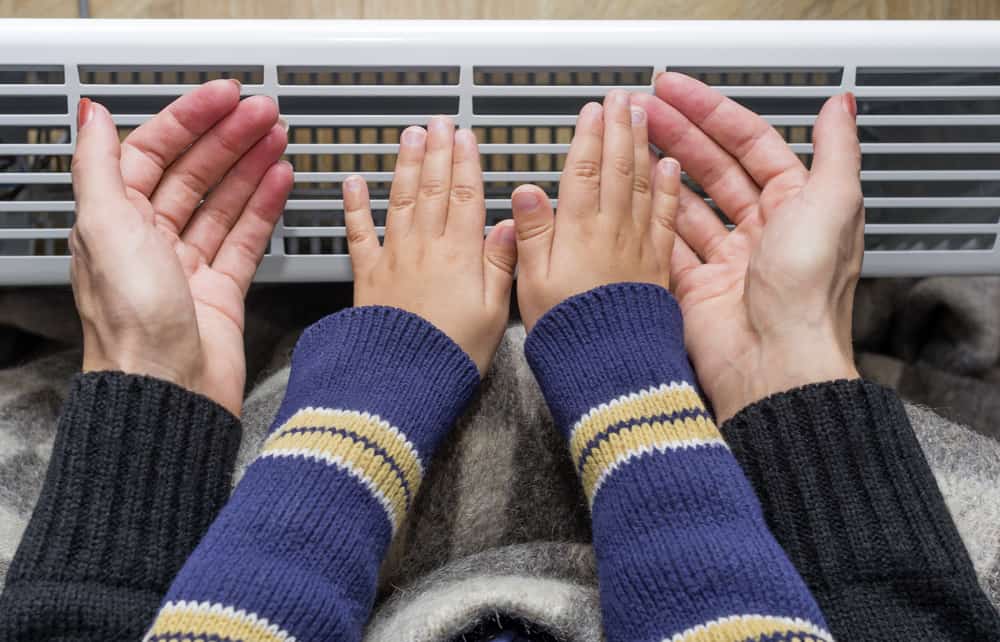 mother and baby warming their hands