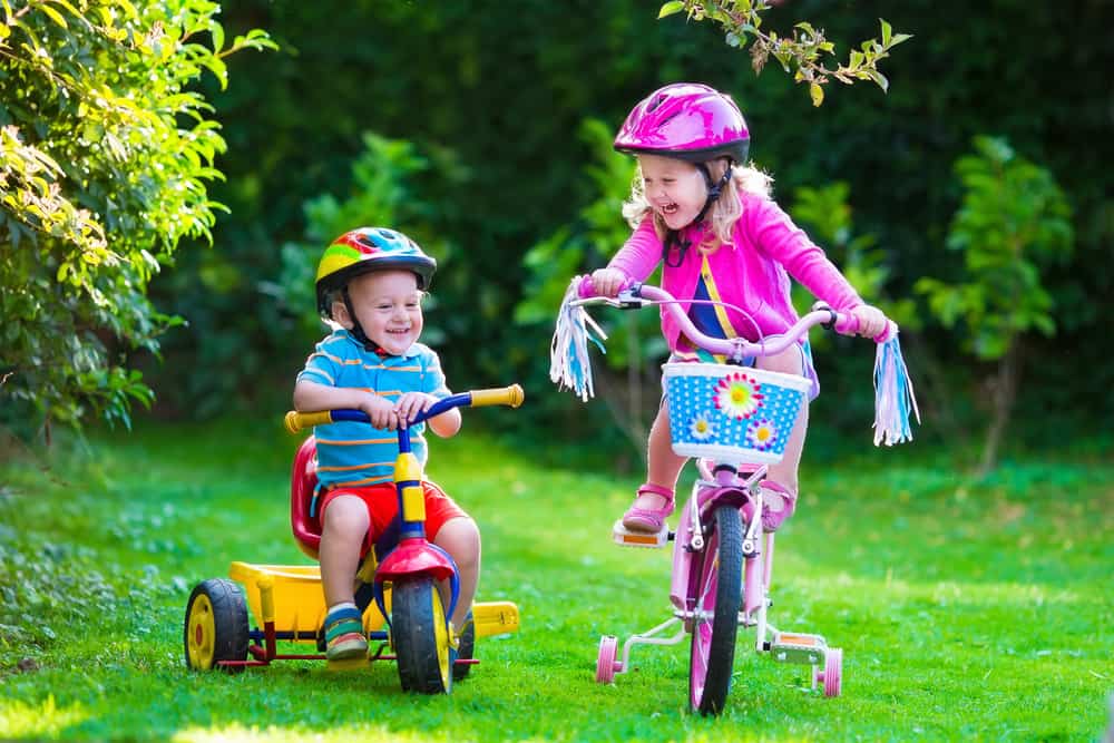 young girl and boy riding bikes