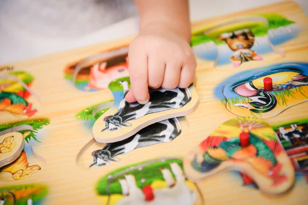Child matching shapes on an activity table