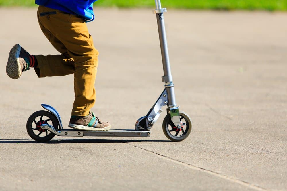 child riding scooter