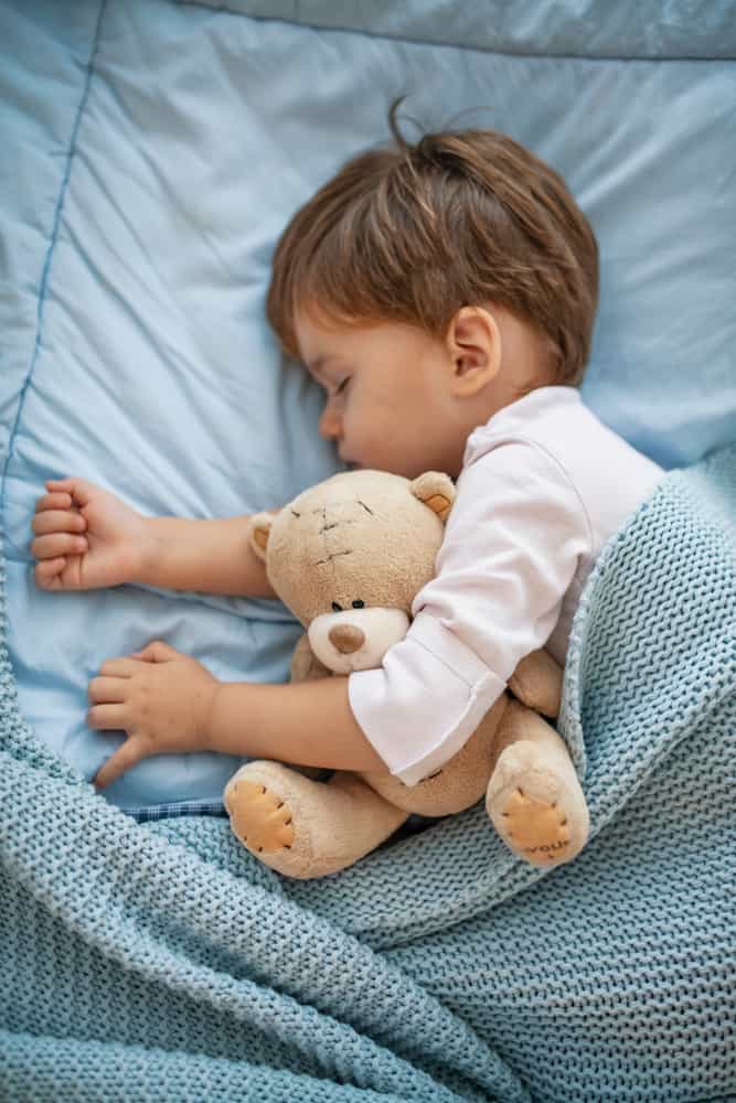 Child sleeping in a nap mat