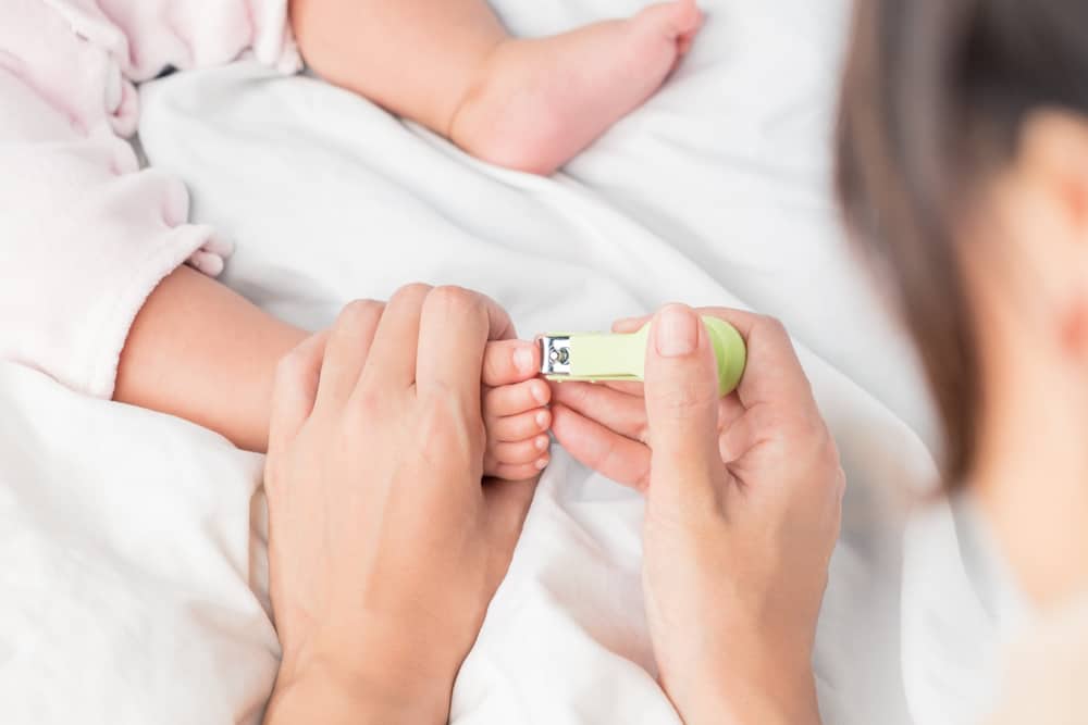 Close up of parent cutting baby’s toe nails