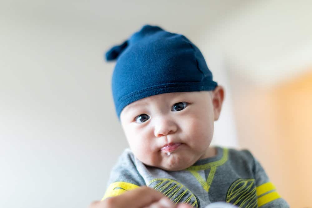 baby with spit up on his lips