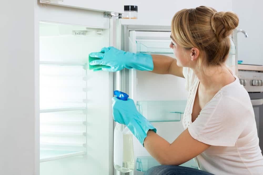 woman cleaning fridge