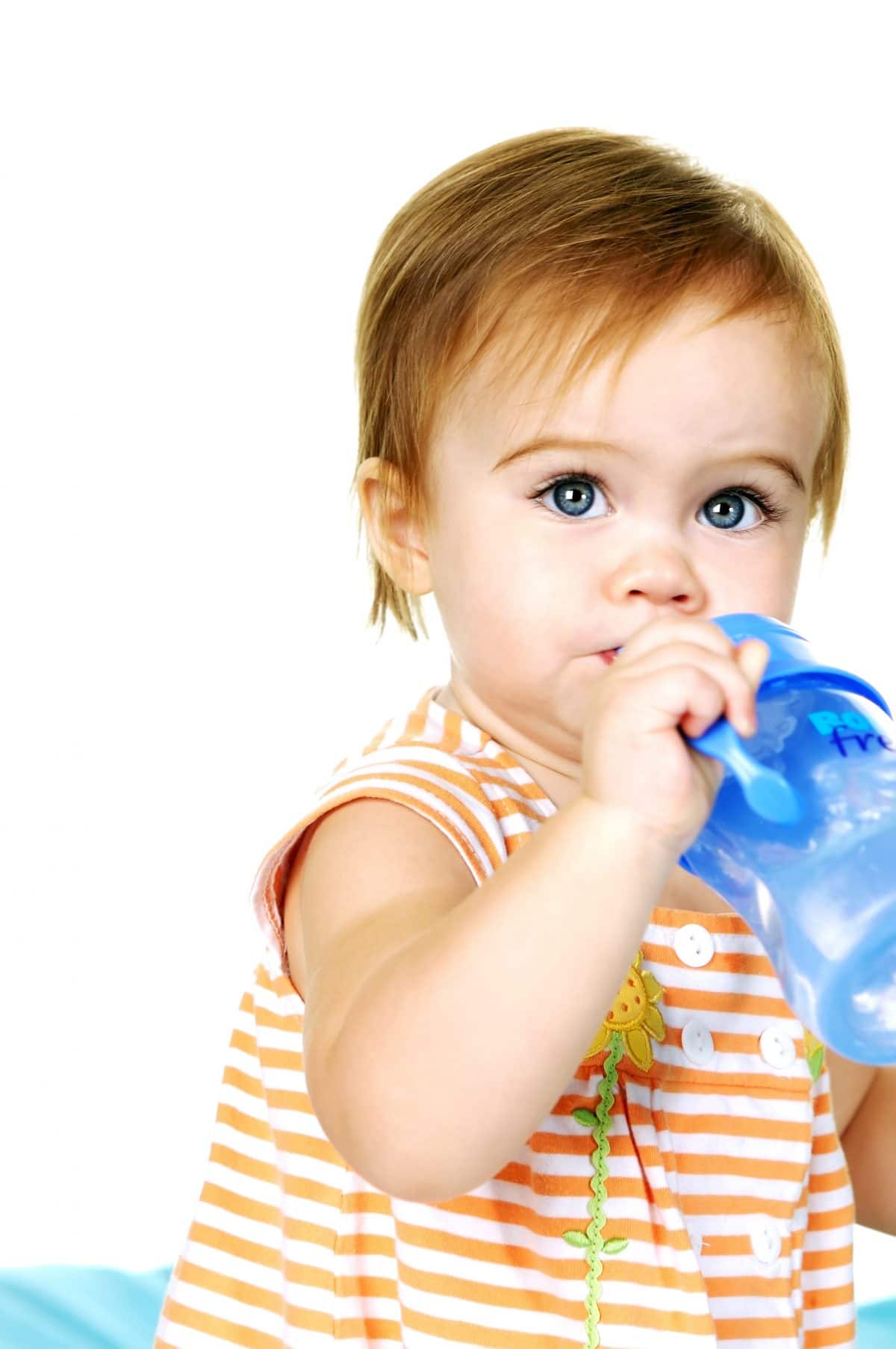 toddler drinking water from a sippy cup