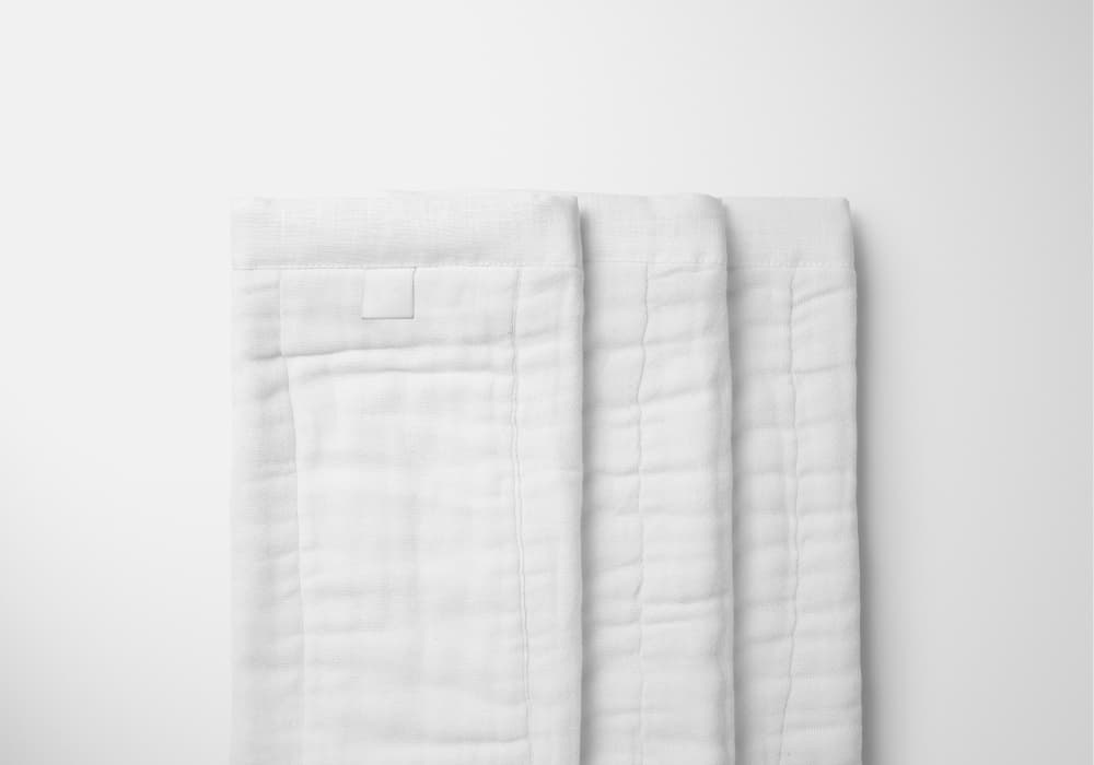 Three white burp cloths