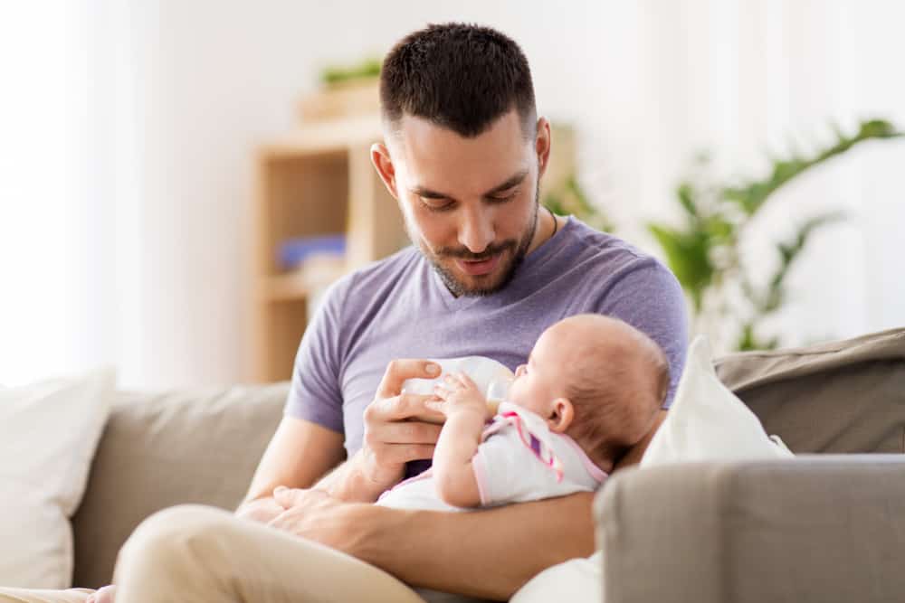 father bottle-feeding a baby