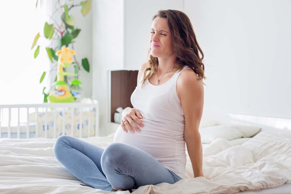 young pregnant woman having contractions